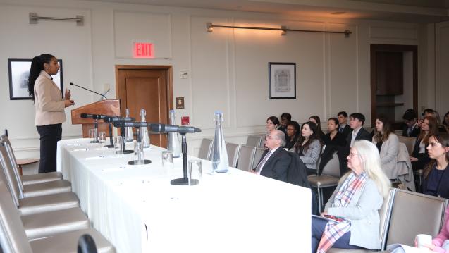 A student presenting their Workshop project to a panel and audience.
