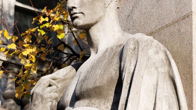 Exterior closeup shot looking at statue with autumn leaves in background at Morningside