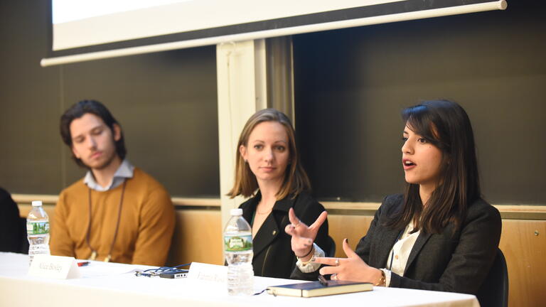 students and alumni speaking on a panel