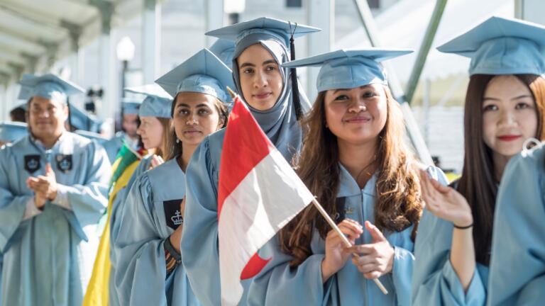 A group of graduates wearing cap and gown