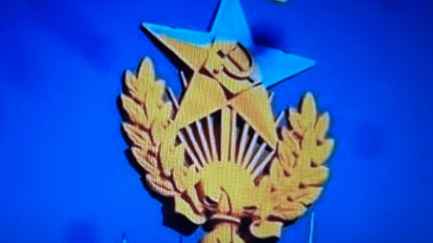 Image of a star with hammer and sickle in the color of the Ukrainian flag. 