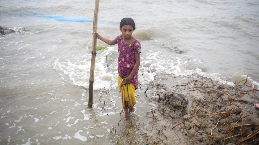 Young Bengali girl in polluted oceanside