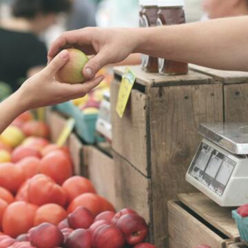 person handing fruit to another person