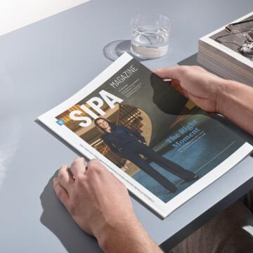 SIPA Magazine Fall 2022 Issue held by reader