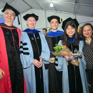 PhD Student being congratulated by faculty during SIPA Class Day Reception.