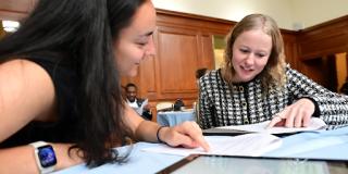 A photo of two students studying a problem set in a Columbia library.