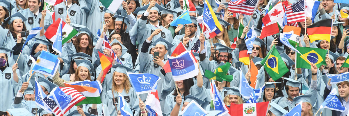 Graduates of SIPA holding world flags
