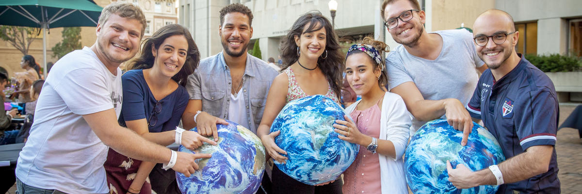 students holding globes