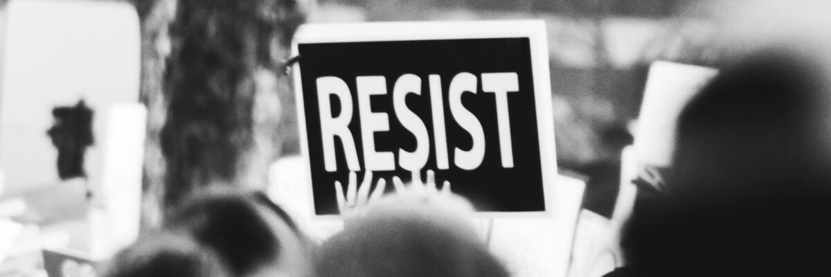 resist sign being held at protest