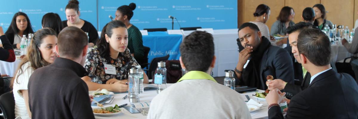 MPA-ESP Students sitting at round tables at an event 