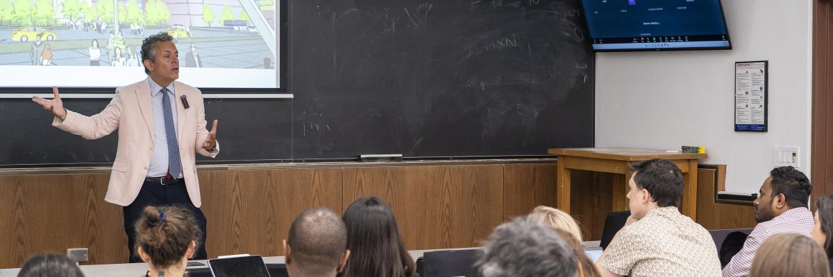 EMPA Class lecture: Instructor presenting architectural concepts to students in person and via video conference.