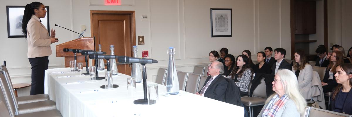 A student presenting their Workshop project to a panel and audience.
