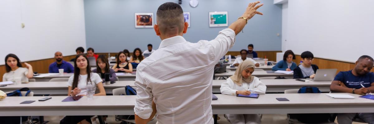 An instructor teaching an engaged group of SIPA students in a classroom.