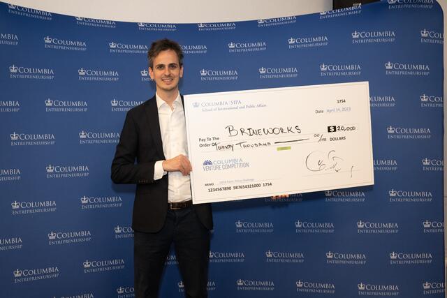 Brineworks founder holding his prize check.