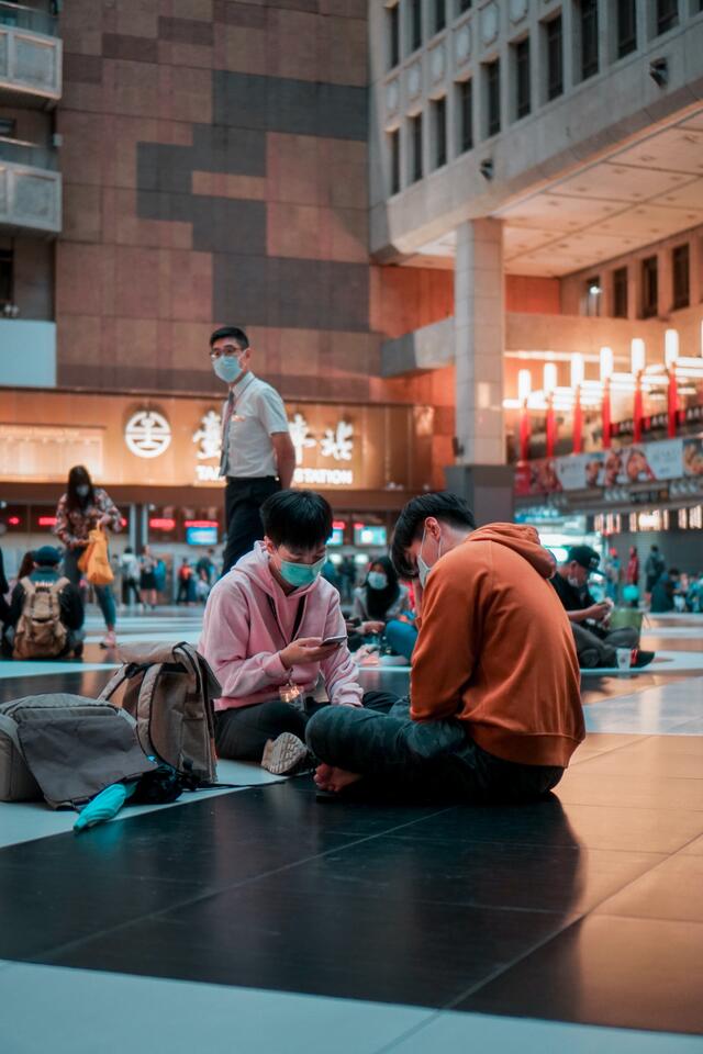 people wear masks at a train station in Taipei, Taiwan