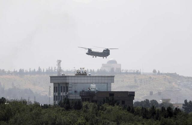 A U.S. Chinook helicopter flies near the U.S. Embassy in Kabul, Afghanistan, Sunday, Aug. 15, 2021.